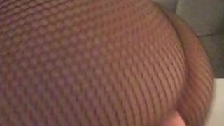 Teen in fishnet bodystocking moans as she rides big dildo