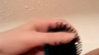 Young slut fucks her tight pussy with a hairbrush